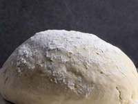 Photo of a ball of dough on a stone counter
